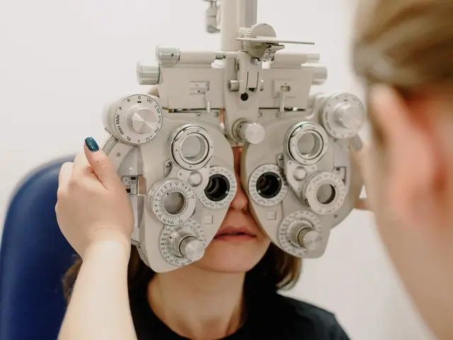 Optician carrying out an eye examination using a phoropter