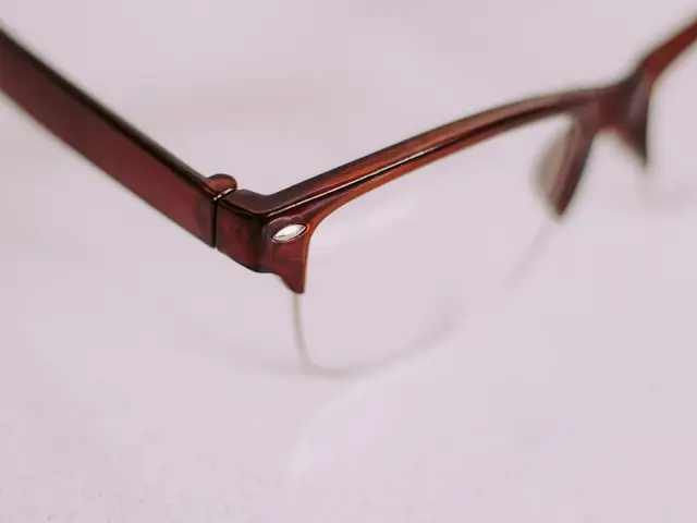 Close-up of a pair of glasses frames on a plain surface