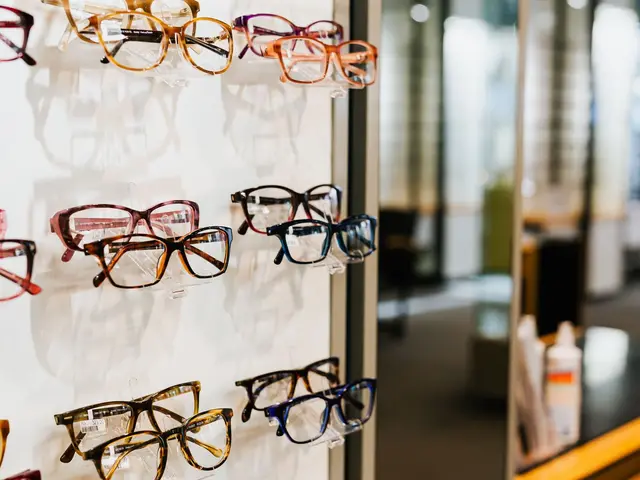 Wall of colourful glasses frames on display in an opticians showroom